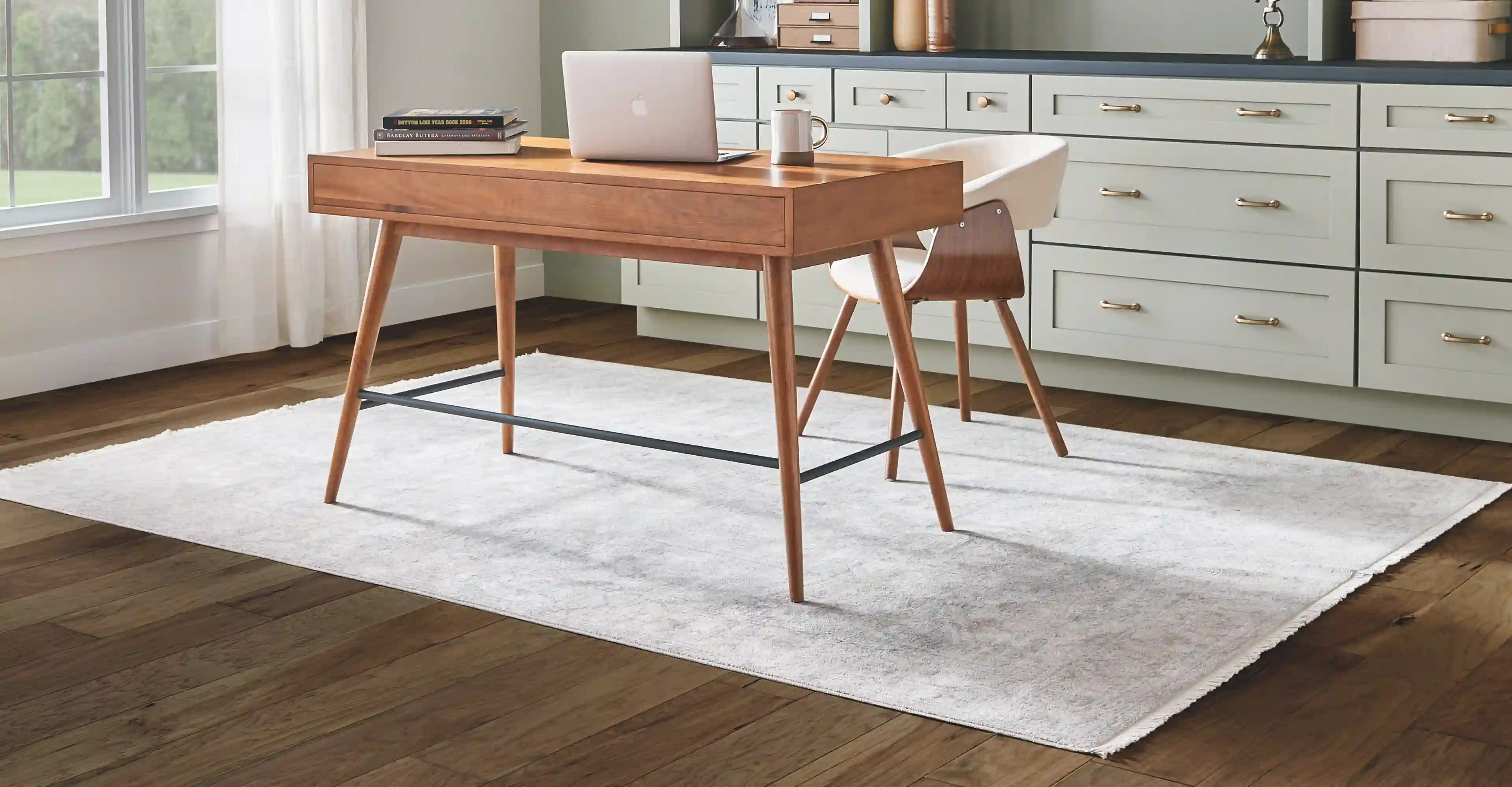Area rug over hardwood flooring in a home office